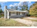 Gray ranch house with mature trees and a spacious driveway at 4257 Midway Rd, Douglasville, GA 30134