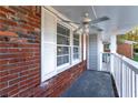 Covered porch with ceiling fan and brick walls at 1396 Gale Dr, Norcross, GA 30093
