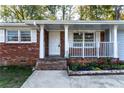 Front porch with white columns and railing at 1396 Gale Dr, Norcross, GA 30093