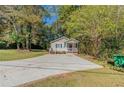 Newly built house with a large yard and a paved driveway at 3464 Linecrest Rd, Ellenwood, GA 30294