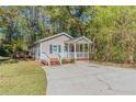 Newly built house with a large yard and a paved driveway at 3464 Linecrest Rd, Ellenwood, GA 30294
