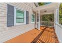 Inviting front porch with white railings and an orange-stained deck at 3464 Linecrest Rd, Ellenwood, GA 30294