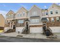 Three-story townhouses with attached garages and stairs at 4262 Buford Valley Way, Buford, GA 30518