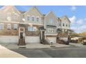 Three-story townhouses with attached garages and stairs at 4262 Buford Valley Way, Buford, GA 30518