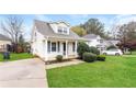 House exterior showcasing a cozy front porch and neatly landscaped yard at 417 Tina Hely Ct, Stockbridge, GA 30281