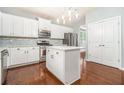 Modern kitchen with white cabinets, island, and stainless steel appliances at 2166 Leatherstone Dr, Powder Springs, GA 30127