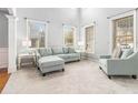 Bright living room with light grey walls, plush seating, and hardwood floors at 2166 Leatherstone Dr, Powder Springs, GA 30127