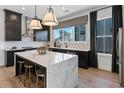 Modern kitchen with white quartz island, black cabinetry, stainless steel appliances, and hardwood floors at 2617 Mackintosh Ct # 3, Brookhaven, GA 30319
