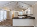Eat-in kitchen with granite counters, white cabinets, and exposed beams at 3619 Colonial Trl, Douglasville, GA 30135