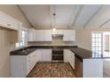 Eat-in kitchen with granite counters, white cabinets, and exposed beams at 3619 Colonial Trl, Douglasville, GA 30135