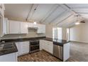 Eat-in kitchen with granite counters, white cabinets, and exposed beams at 3619 Colonial Trl, Douglasville, GA 30135