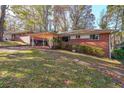 Brick ranch house with carport, and a grassy yard at 2715 Connally Sw Dr, Atlanta, GA 30311