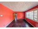 Spacious living room with dark hardwood floors and coral walls at 2715 Connally Sw Dr, Atlanta, GA 30311