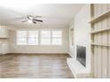 Living room with fireplace, wood-look floors and ceiling fan at 2273 Hampton Locust Grove Rd, Locust Grove, GA 30248