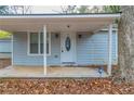 Quaint front porch with light blue siding and white door at 2229 Whites Mill Rd, Decatur, GA 30032