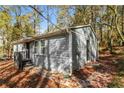 Side view of a newly renovated gray house nestled in a wooded area at 2500 Swallow Se Cir, Atlanta, GA 30315