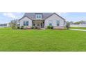 Two-story house with a well-manicured lawn at 112 Leveret Rd, Locust Grove, GA 30248