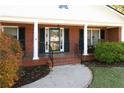 Inviting front porch with brick columns and a view of the landscaping at 1028 Ridge Ave, Stone Mountain, GA 30083