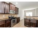 Modern kitchen with stainless steel appliances and granite countertops at 7843 Shertall St, Fairburn, GA 30213