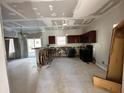 Kitchen undergoing renovations, featuring dark wood cabinets, a breakfast bar, and tiled flooring at 6415 Grey Fox Way, Riverdale, GA 30296