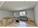 Living room with light gray walls and L-shaped sofa at 3081 Frankie Ln, Duluth, GA 30096