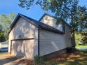 Side view of house with attached garage and neat landscaping at 1812 Lakewood Se Ave, Atlanta, GA 30315