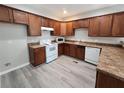 Modern kitchen with wood cabinets, granite countertops, and white appliances at 1812 Lakewood Se Ave, Atlanta, GA 30315