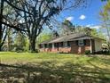 Brick ranch home with a large front yard and mature trees at 2962 Mcafee Rd, Decatur, GA 30032