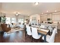 Open concept kitchen and dining area with hardwood floors and modern fixtures at 580 Pennsy Aly, Mableton, GA 30126