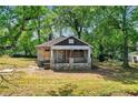 Stone cottage with porch, needs renovation, surrounded by trees at 1162 Joseph E Boone Nw Blvd, Atlanta, GA 30314