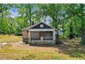 Stone cottage with porch, needs renovation, surrounded by trees at 1162 Joseph E Boone Nw Blvd, Atlanta, GA 30314