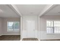 Bright entryway with white wainscoting and hardwood floors at 909 Galloway Ct, Mcdonough, GA 30253