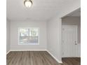 Simple dining room with hardwood floors and window at 909 Galloway Ct, Mcdonough, GA 30253