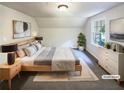 Virtually staged main bedroom with a king-size bed and ample natural light at 4405 Cary Dr, Snellville, GA 30039