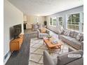 Virtually staged living room with gray couches and coffee table at 4405 Cary Dr, Snellville, GA 30039