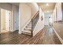 Light-filled foyer with hardwood floors and a modern staircase at 4171 Viola Pl, Atlanta, GA 30349