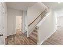 Carpeted staircase with neutral-toned walls and hardwood floors at 4171 Viola Pl, Atlanta, GA 30349