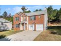 Two-story brick home with attached garage, driveway, and basketball hoop at 6634 Pine Valley Trce, Stone Mountain, GA 30087
