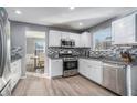 Modern kitchen with stainless steel appliances and granite countertops at 6634 Pine Valley Trce, Stone Mountain, GA 30087