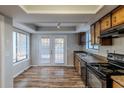 Eat-in kitchen with wood cabinets, stainless steel appliances, and vinyl flooring at 9887 Live Oak Ct, Douglasville, GA 30135