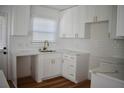 Renovated kitchen with white shaker cabinets, quartz countertops, and gold hardware at 2502 Tupelo Se St, Atlanta, GA 30317