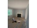 Living room with hardwood floors and a fireplace; currently under renovation at 5621 Zanola Sw Dr, Mableton, GA 30126