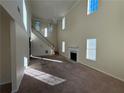 Spacious living room with high ceilings, fireplace, and large windows at 5750 Old Carriage Dr, Atlanta, GA 30349