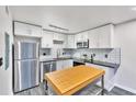 Modern kitchen with stainless steel appliances and white shaker cabinets at 89 Chaumont Nw Sq, Atlanta, GA 30327