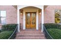 Double wood front doors with brick entryway and railings at 2237 Gunstock Dr, Stone Mountain, GA 30087