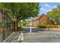 Row of brick townhomes in a gated community with tree-lined street at 4738 Ivy Ridge Se Dr, Atlanta, GA 30339