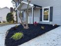 Landscaped front yard with manicured plants and shrubs near the entrance at 1463 Martin Nash Sw Rd, Lilburn, GA 30047