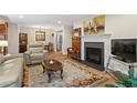 Inviting living room featuring fireplace, leather furniture, and area rug at 1594 Alexandria Se Ct, Marietta, GA 30067