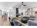 Open concept living room with kitchen views, modern furniture, and hardwood floors at 392 Pratt Se Dr # 2023, Atlanta, GA 30315