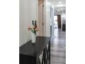 Bright hallway with black accent table and flowers at 1280 W Peachtree Nw St # 914, Atlanta, GA 30309